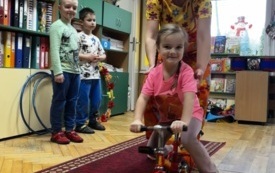DZIEWCZYNKA Z POMOCĄ ARTYSTKI CYRKOWEJ JEDZIE NA MINIROWERKU