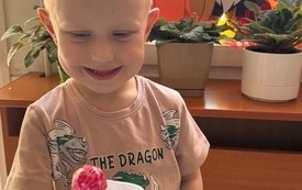 CHŁOPIEC Z RADOŚCIĄ PRZYJMUJE PREZENT-UCHWYT Z LIZAKIEM