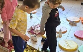 JESIENNA ŚCIEŻKA SENSORYCZNA, DZIECI GOŁYMI STOPAMI CHODZĄ PO DARACH JESIENI