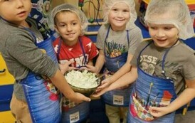 Chłopcy z grupy zając&oacute;w pozują w strojach kulinarnych z miską mizerii